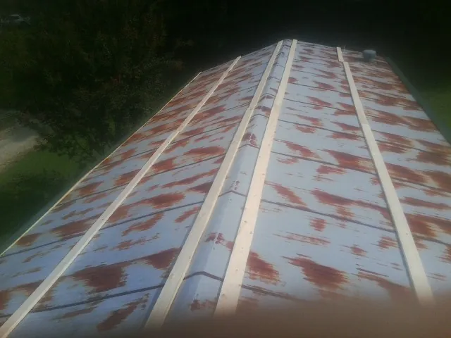 Rusted metal roof panels with new wood purlins before replacement — Storm Damage Roof Repair in Collierville by Roofing Brothers