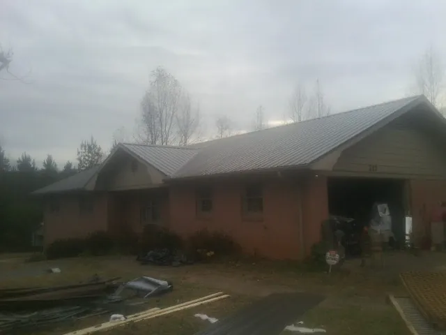 Gray metal roof on a stucco house with an attached garage in Collierville