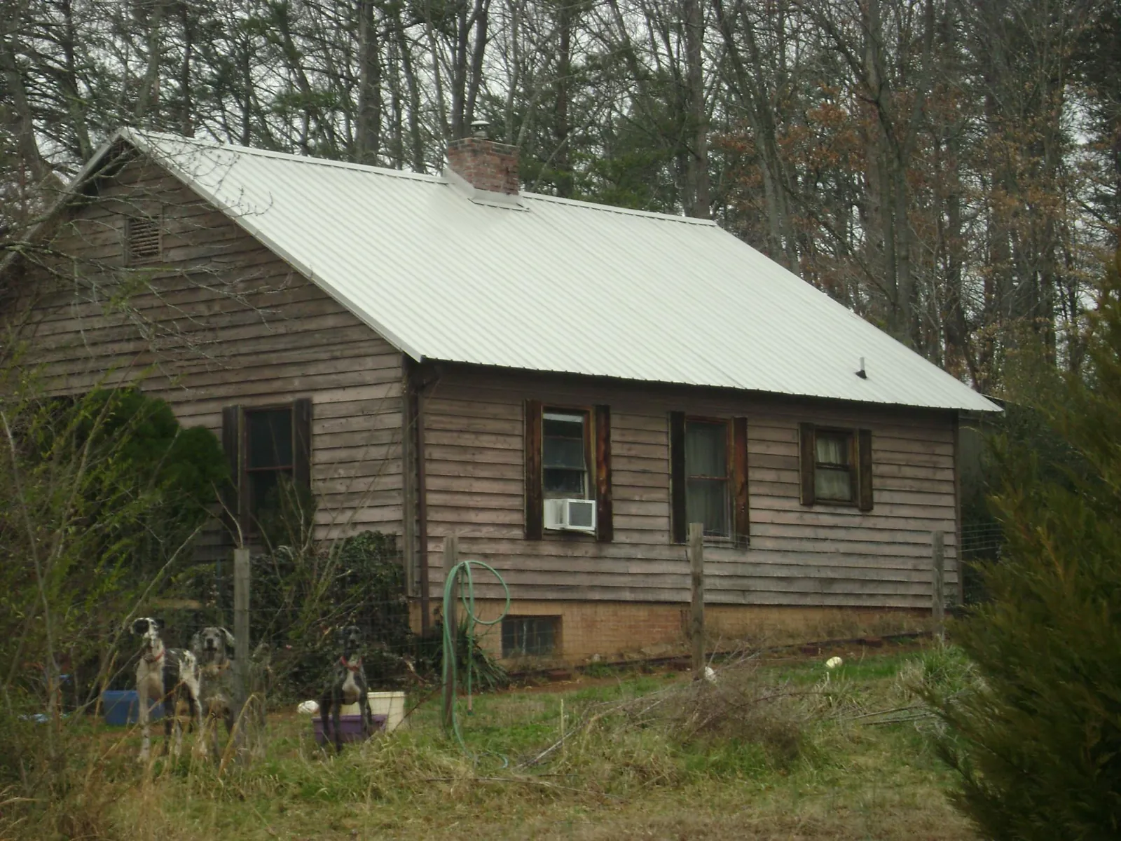 White metal roof on an old wood sided farmhouse, from a Asphalt Shingle Roof Repair job in Collierville